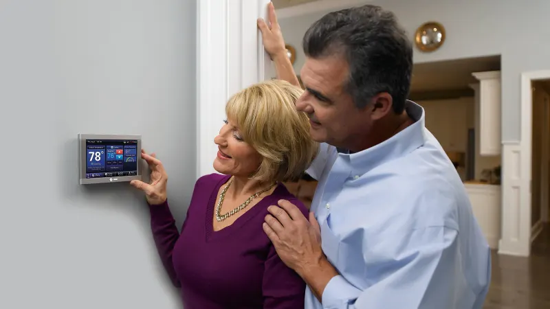Couple Using Trane Smart Thermostat