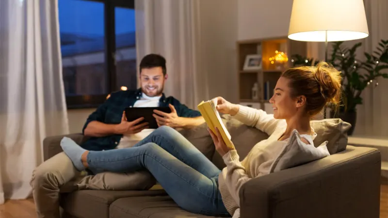 Man And Woman Relaxing In Living Room