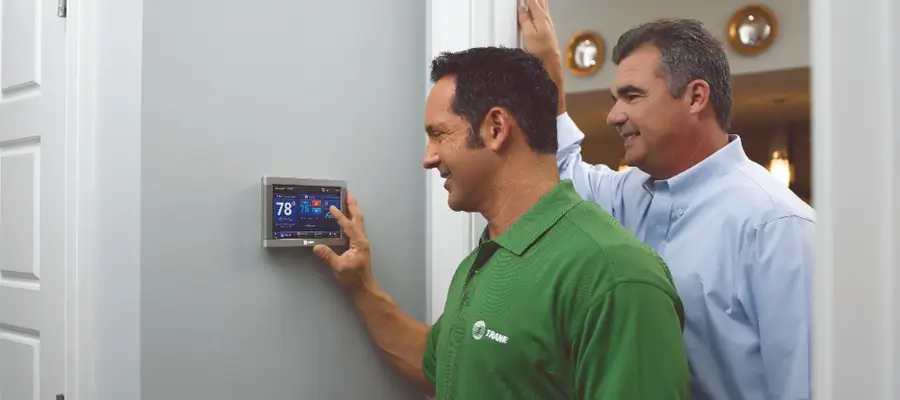 Trane Dealer Showing Home Owner How To Use Smart Thermostat (1)
